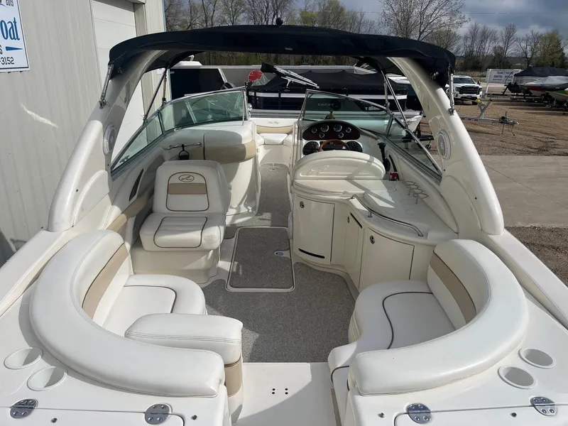 Slide: The Image of 2003 Sea Ray 290 Bowrider with spacious seating and sleek design, docked outdoors. - 10