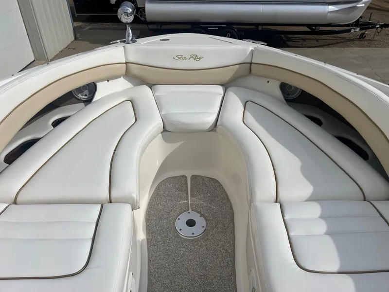 Slide: The Image of 2003 Sea Ray 290 Bowrider with white cushioned seating and carpeted floor. - 11