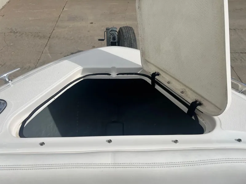 Slide: The Image of Open storage compartment on a 2003 Sea Ray 290 Bowrider boat. - 12