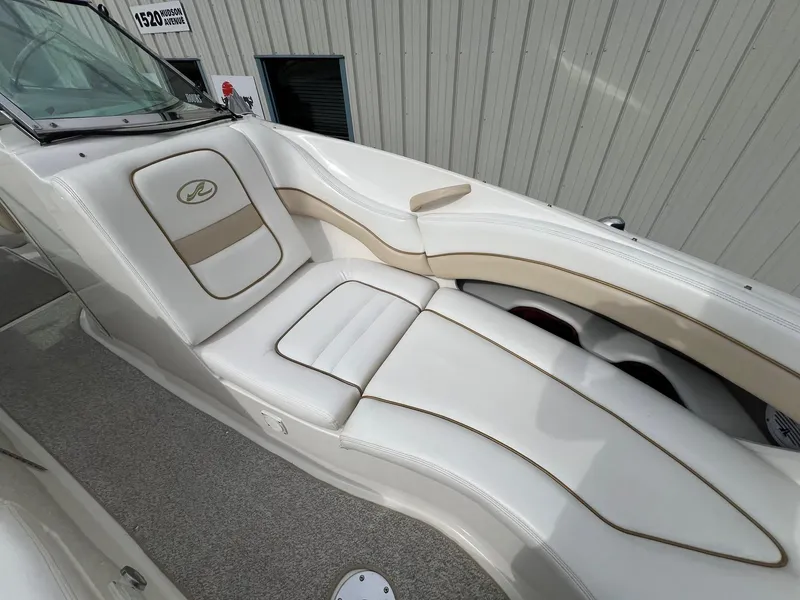 Slide: The Image of 2003 Sea Ray 290 Bowrider interior with white and beige seating, showcasing luxury design. - 14