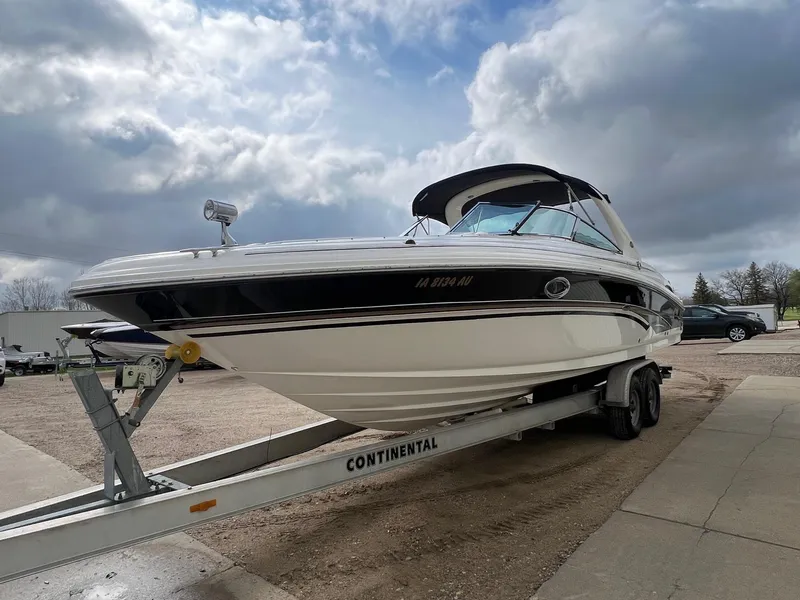 Slide: The Image of 2003 Sea Ray 290 Bowrider on trailer under cloudy sky. - 2