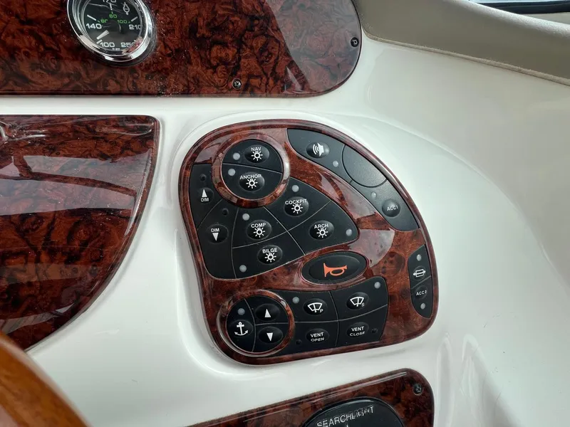 Slide: The Image of Control panel of a 2003 Sea Ray 290 Bowrider boat with woodgrain finish. - 20