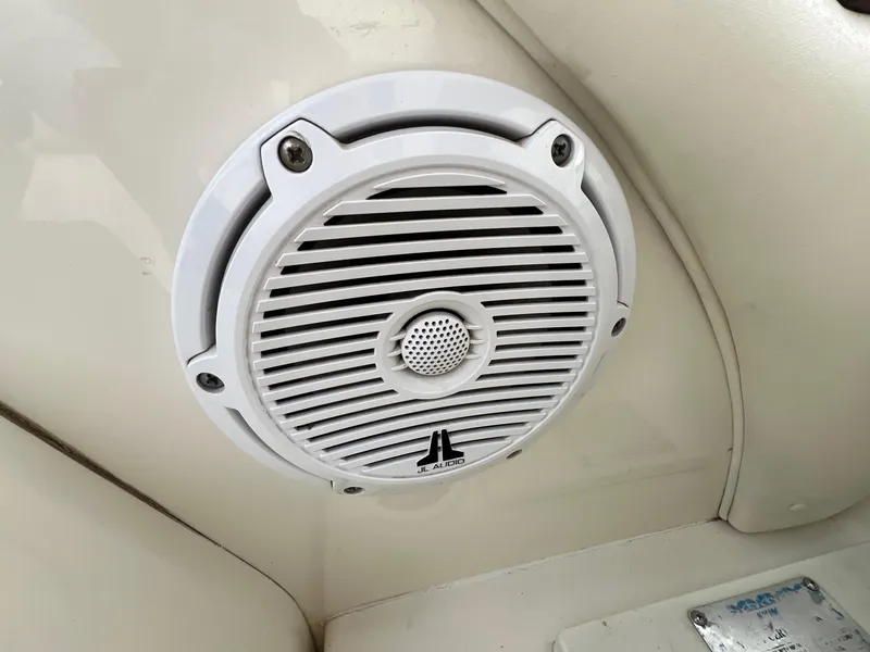 Slide: The Image of White JL Audio speaker on 2003 Sea Ray 290 Bowrider boat interior. - 25