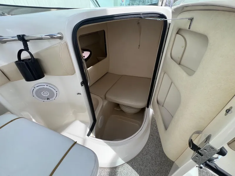 Slide: The Image of 2003 Sea Ray 290 Bowrider interior cabin with seating and storage. - 28