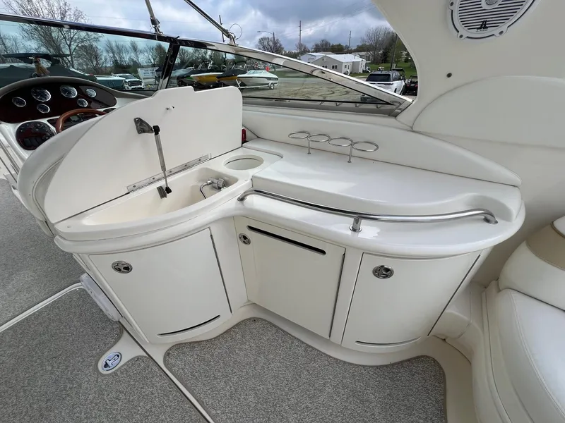 Slide: The Image of 2003 Sea Ray 290 Bowrider interior with sink and storage area. - 29
