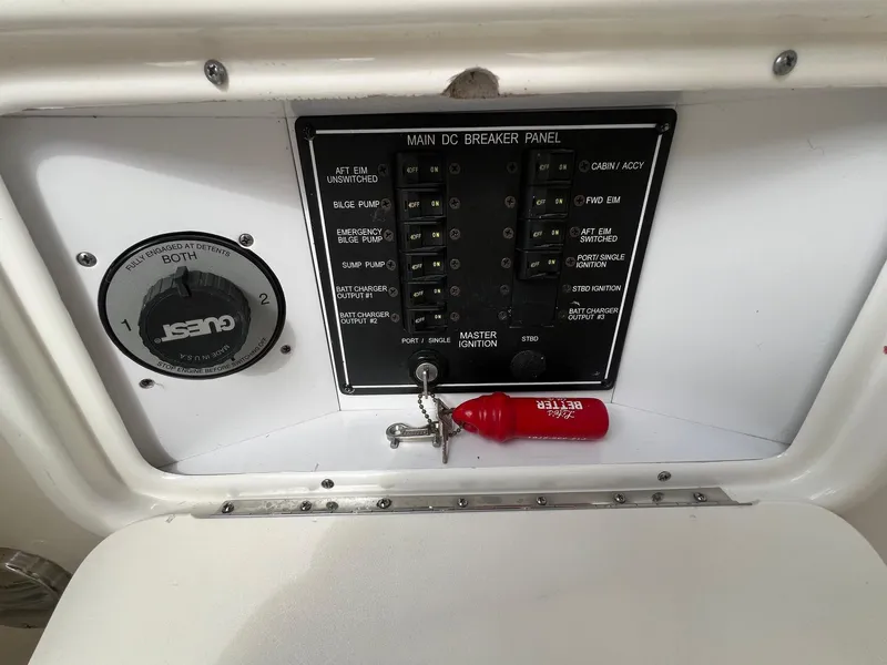 Slide: The Image of 2003 Sea Ray 290 Bowrider main DC breaker panel with ignition switch and gauge. - 33