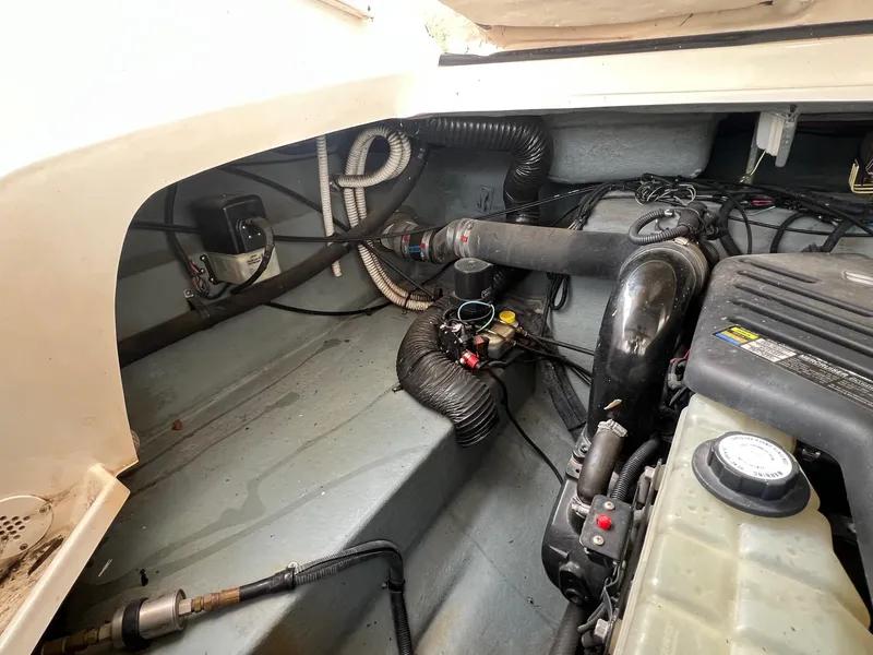 Slide: The Image of Engine compartment of a 2003 Sea Ray 290 Bowrider boat, showing mechanical components and wiring. - 37