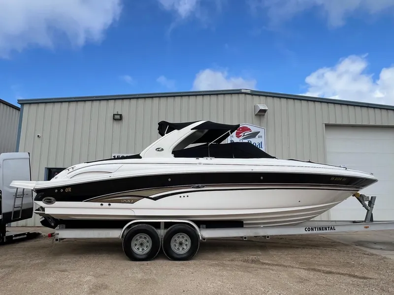 Slide: The Image of 2003 Sea Ray 290 Bowrider boat on trailer, parked outside a building. - 40