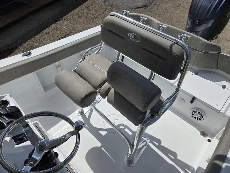 Slide: The Image of 2025 Sea Hunt Ultra 219 boat interior with steering wheel and cushioned seating. - 12