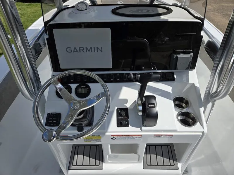 Slide: The Image of 2025 Sea Hunt Ultra 219 boat console with Garmin navigation system and steering wheel. - 14
