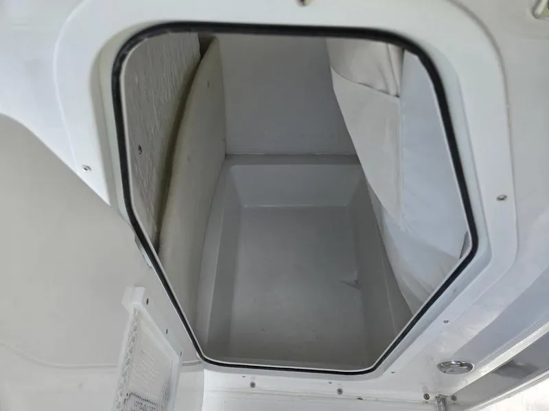 Slide: The Image of Compartment interior of 2025 Sea Hunt Ultra 219 boat, featuring a clean, white finish. - 2