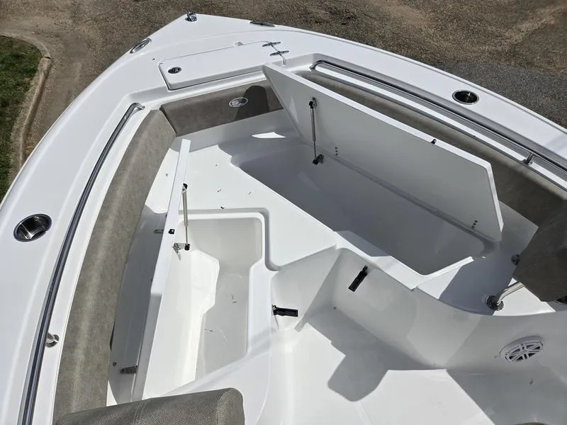 Slide: The Image of 2025 Sea Hunt Ultra 219 boat interior with open storage compartments and seating. - 6