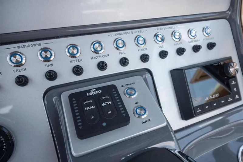 Slide: The Image of Control panel of 2023 ShearWater 260 Carolina SS boat with audio system and switches. - 19