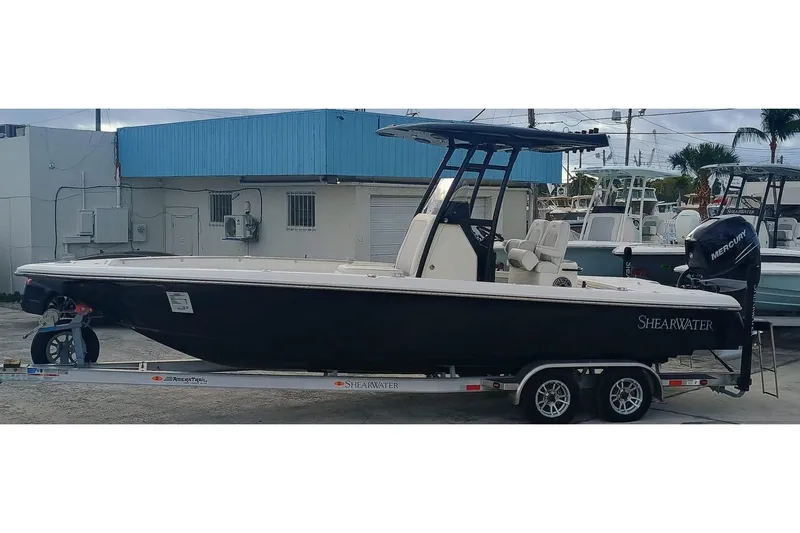 Slide: The Image of 2023 ShearWater 260 Carolina SS boat on trailer, parked outdoors. - 3