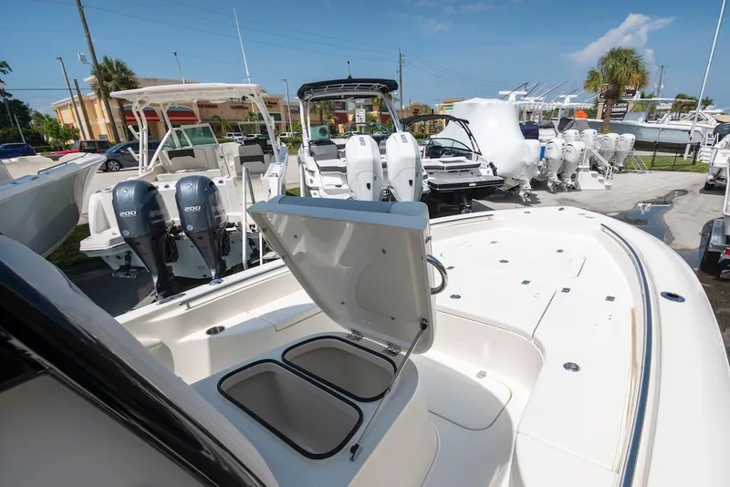 Slide: The Image of 2023 ShearWater 260 Carolina SS boat with open storage, displayed in a marina. - 6