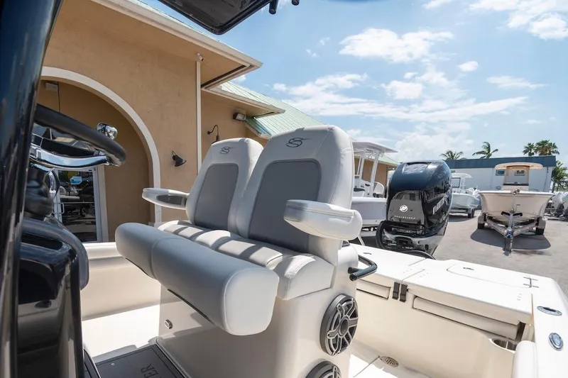 Slide: The Image of 2023 ShearWater 260 Carolina SS boat interior with dual seats and outboard motor. - 7