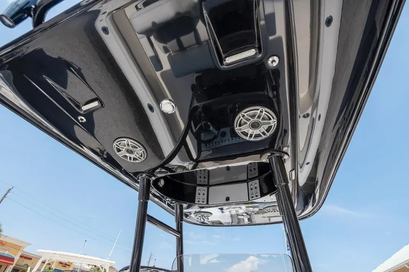 Slide: The Image of 2023 ShearWater 260 Carolina SS boat with sleek black T-top and speakers. - 8