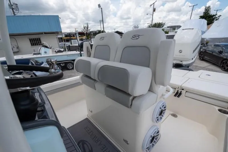 Slide: The Image of 2023 ShearWater 260 SS boat seating with dual speakers and steering wheel. - 18
