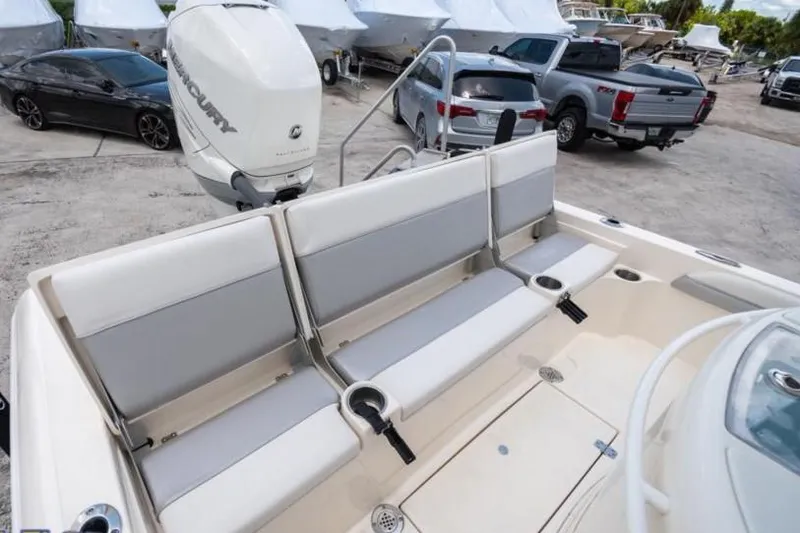 Slide: The Image of 2023 ShearWater 260 SS boat with seating and Mercury outboard motor in a marina. - 19