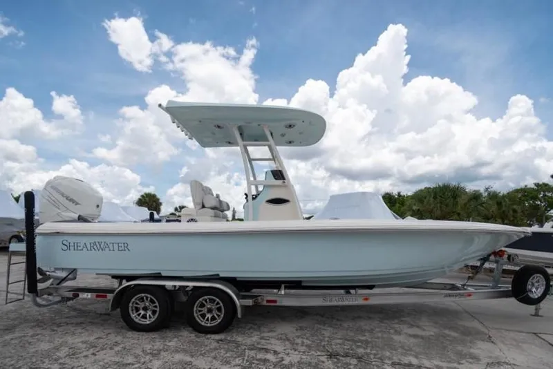 Slide: The Image of 2023 ShearWater 260 SS boat on trailer under cloudy sky. - 2