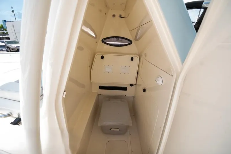 Slide: The Image of 2023 ShearWater 260 SS boat interior cabin with storage and seating. - 22