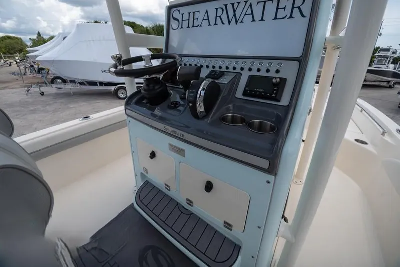 Slide: The Image of 2023 ShearWater 260 SS boat console with steering wheel and controls. - 25