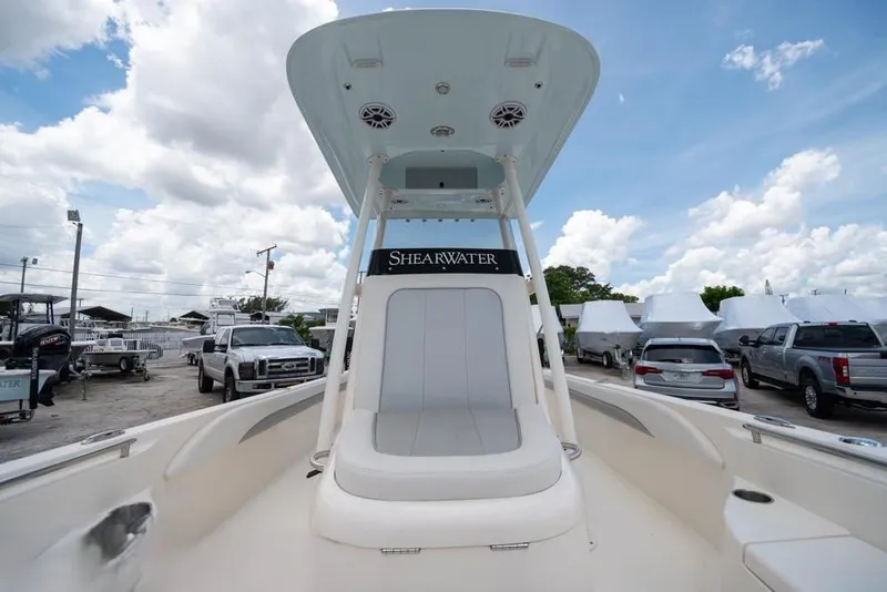 Slide: The Image of 2023 ShearWater 260 SS boat with seating, parked under a cloudy sky. - 26