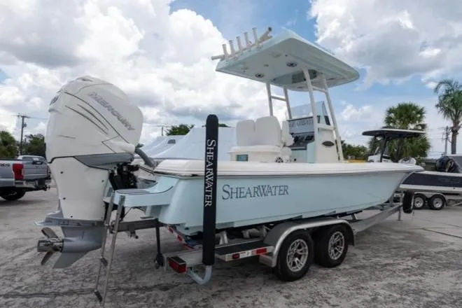 Slide: The Image of 2023 ShearWater 260 SS boat on trailer, featuring sleek design and powerful engine. - 5