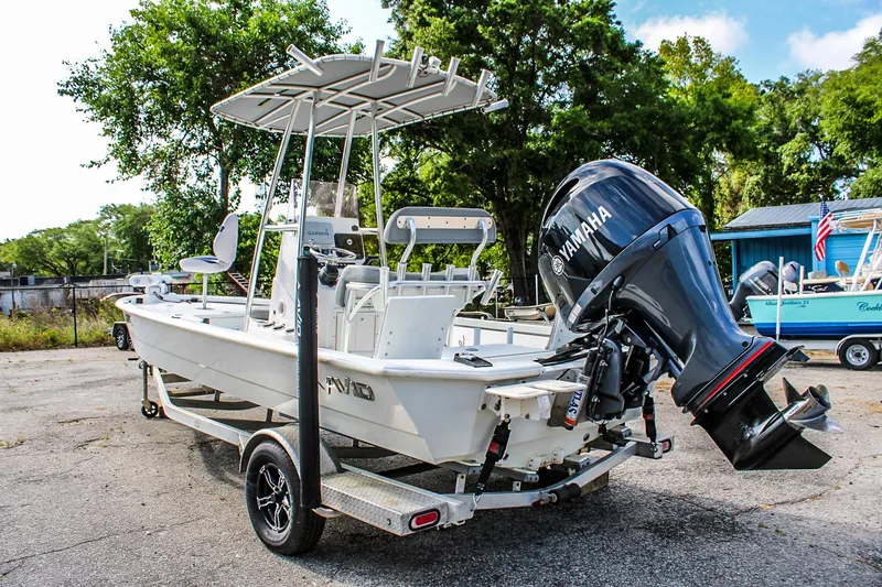 Slide: The Image of 2021 Avid 21 FS boat with Yamaha outboard motor on trailer, parked outdoors. - 1
