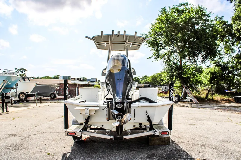 Slide: The Image of 2021 Avid 21 FS boat on trailer, rear view, parked outdoors. - 3