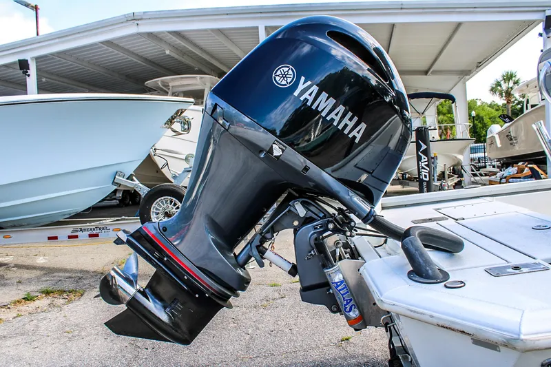Slide: The Image of 2021 Avid 21 FS boat with Yamaha outboard motor in a marina setting. - 5