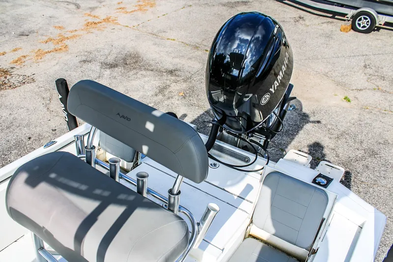 Slide: The Image of 2021 Avid 21 FS boat with Yamaha outboard motor, featuring seating and rod holders. - 7