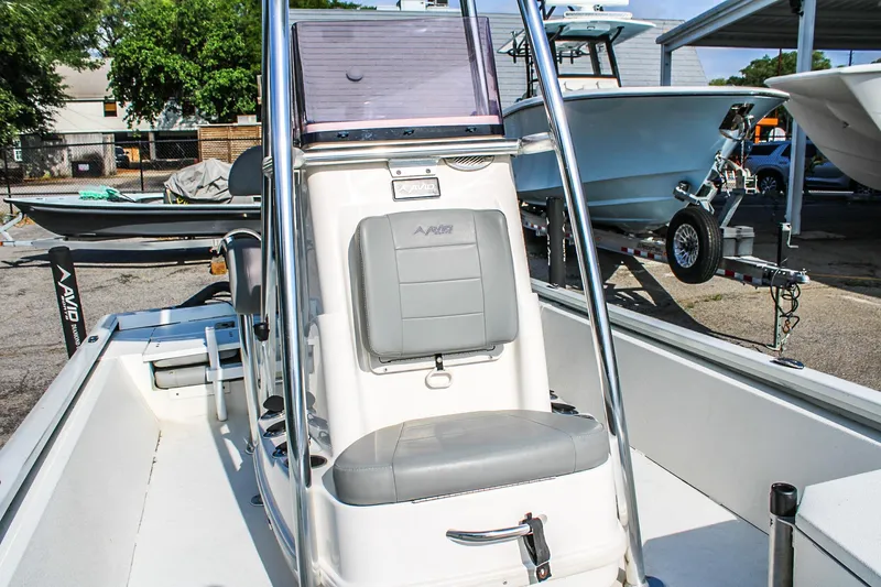 Slide: The Image of 2021 Avid 21 FS boat with center console and seating, parked outdoors. - 8