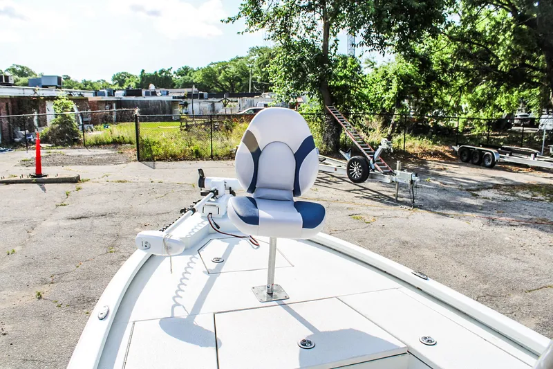 Slide: The Image of 2021 Avid 21 FS boat with a swivel seat on deck, parked outdoors. - 9
