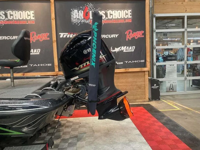 Slide: The Image of 2018 Phoenix 20 PHX boat motor displayed at a trade show with branded backdrop. - 2