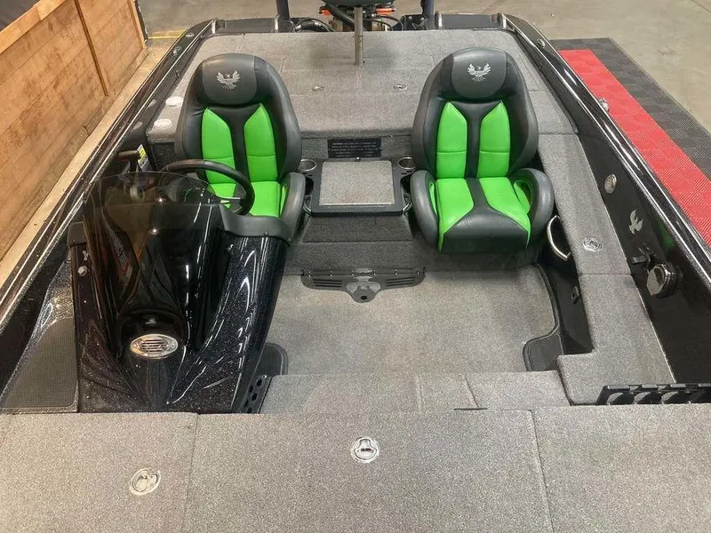 Slide: The Image of 2018 Phoenix 20 PHX boat interior with green and black seats, steering console, and spacious layout. - 9