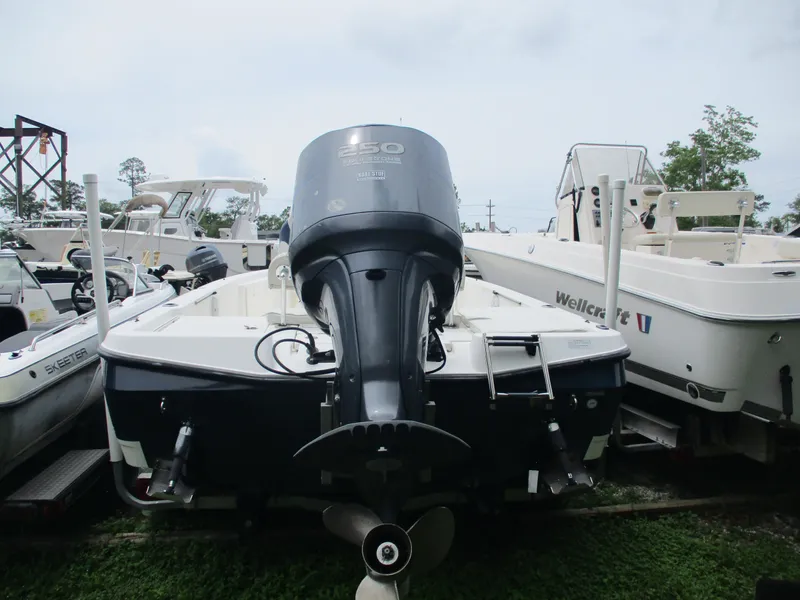 Slide: The Image of 2007 Century 2202 boat with powerful outboard motor, docked among other vessels. - 7