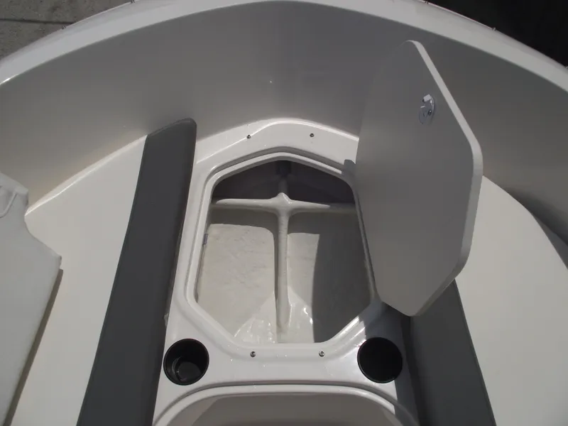 Slide: The Image of 2025 Bayliner Element E16 boat storage compartment with open hatch and cup holders. - 10