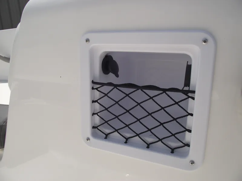 Slide: The Image of Storage compartment with netting on 2025 Bayliner Element E16 boat. - 14