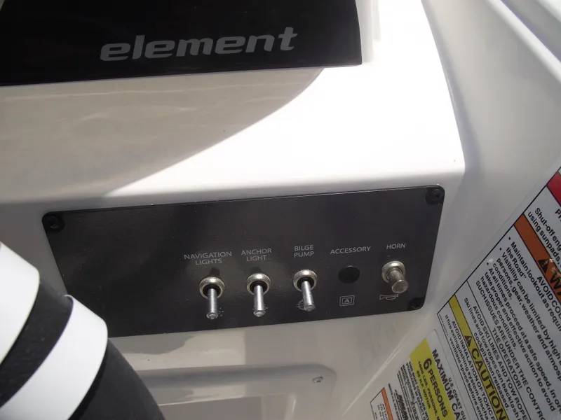 Slide: The Image of Control panel of 2025 Bayliner Element E16 boat with switches and labels. - 17