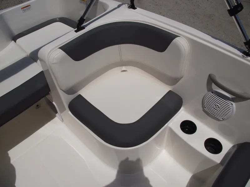 Slide: The Image of 2025 Bayliner Element E16 boat interior with cushioned seating and cup holders. - 23