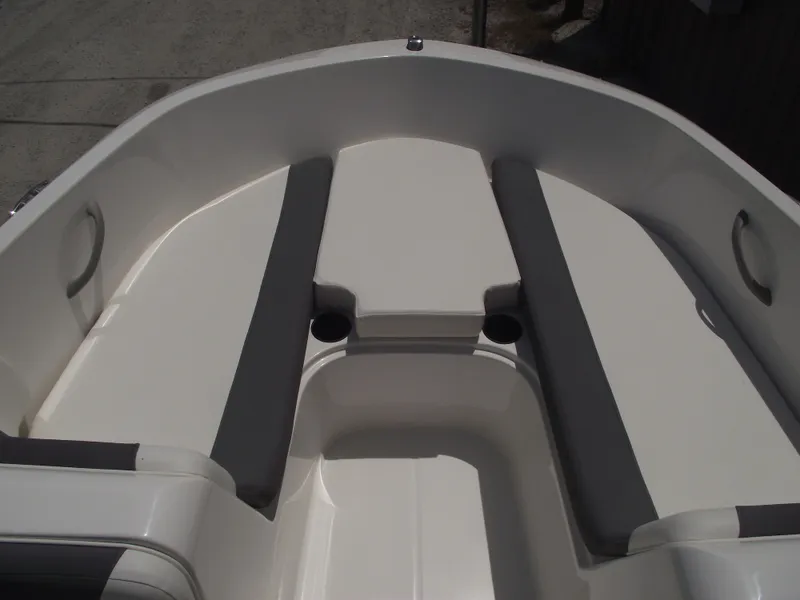 Slide: The Image of 2025 Bayliner Element E16 boat interior with cushioned seating and cup holders. - 5