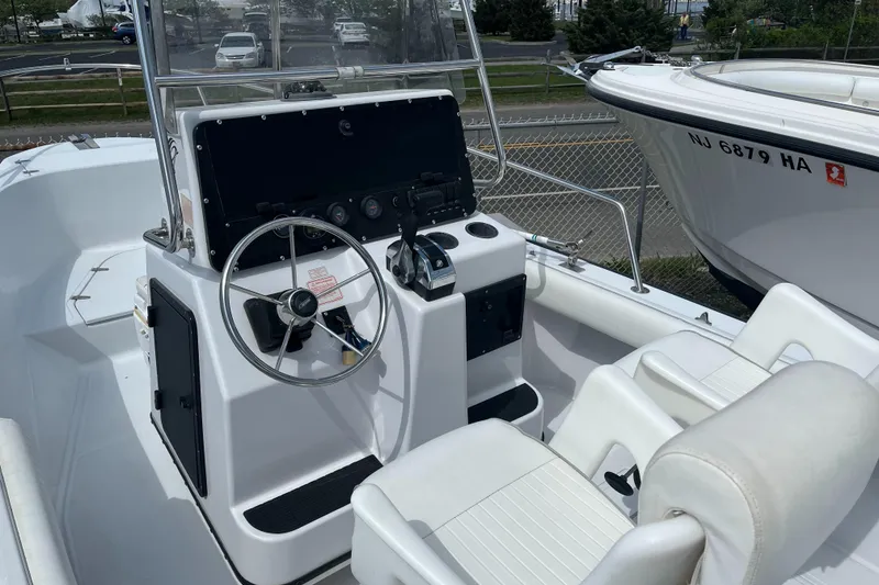 Slide: The Image of 1997 Boston Whaler Outrage 20 boat interior with steering console and seating. - 10