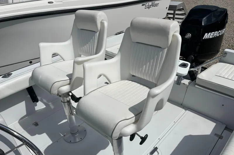 Slide: The Image of Two white cushioned boat seats on a 1997 Boston Whaler Outrage 20. - 11