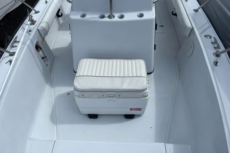 Slide: The Image of 1997 Boston Whaler Outrage 20 boat interior with white seating and console. - 13