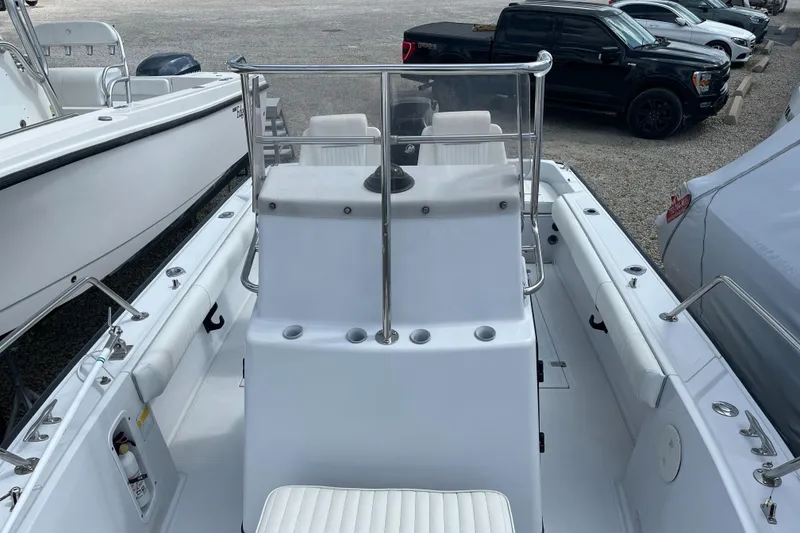 Slide: The Image of 1997 Boston Whaler Outrage 20 boat interior with seating and console, parked in a lot. - 14