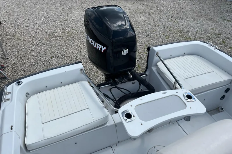 Slide: The Image of 1997 Boston Whaler Outrage 20 boat with Mercury outboard motor, featuring white seating. - 15