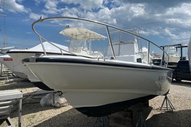 Slide: The Image of 1997 Boston Whaler Outrage 20 boat on display under a partly cloudy sky. - 6