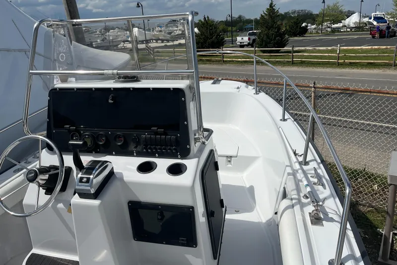 Slide: The Image of 1997 Boston Whaler Outrage 20 boat interior with steering console and controls. - 8