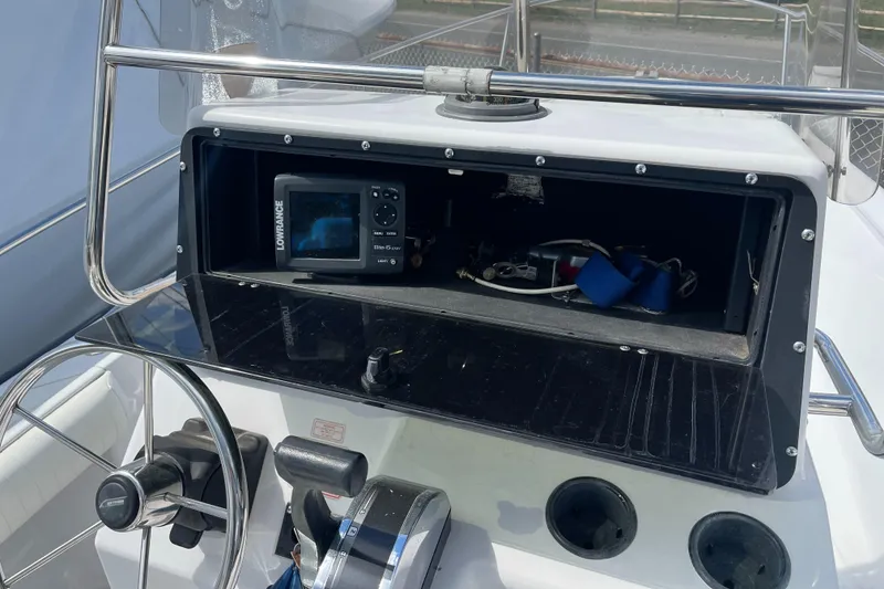 Slide: The Image of 1997 Boston Whaler Outrage 20 dashboard with steering wheel and navigation equipment. - 9